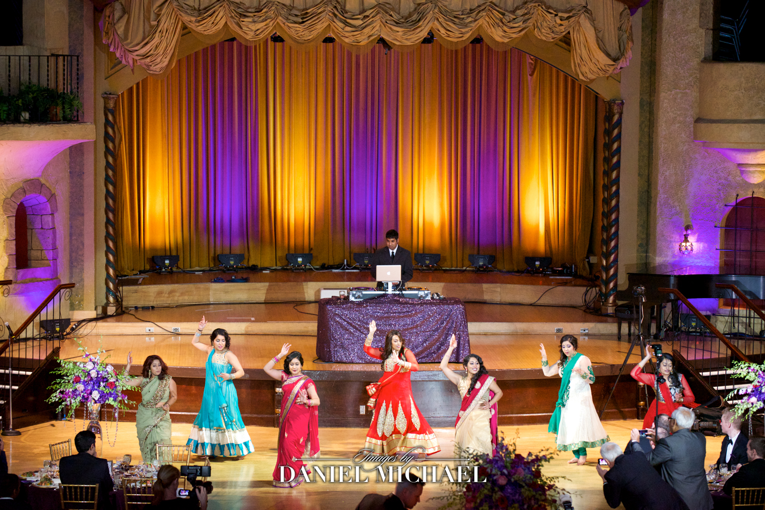 Energetic South Asian group dance at a Cincinnati wedding, showcasing cultural attire and festive atmosphere at Indiana Roof Ballroom